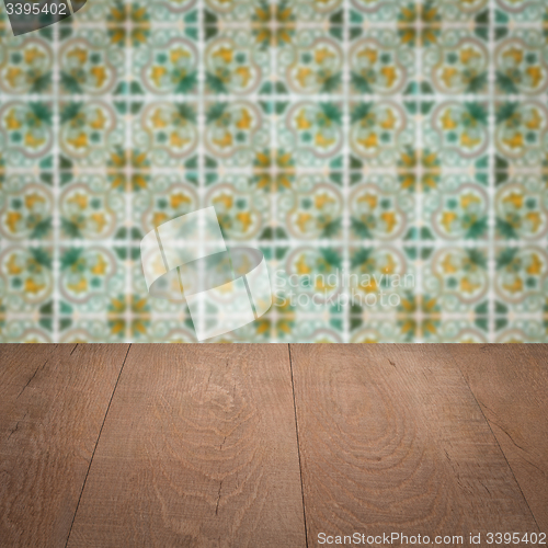 Image of Wood table top and blur vintage ceramic tile pattern wall
