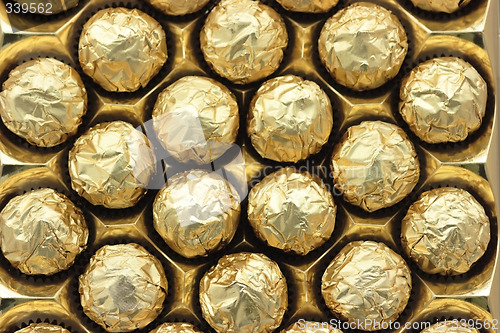 Image of Chocolate sweets in golden foil