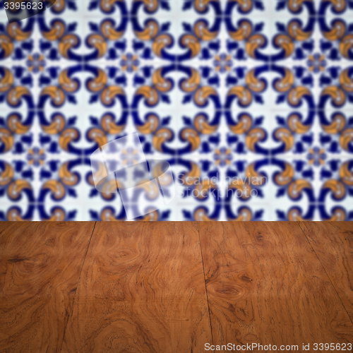 Image of Wood table top and blur vintage ceramic tile pattern wall