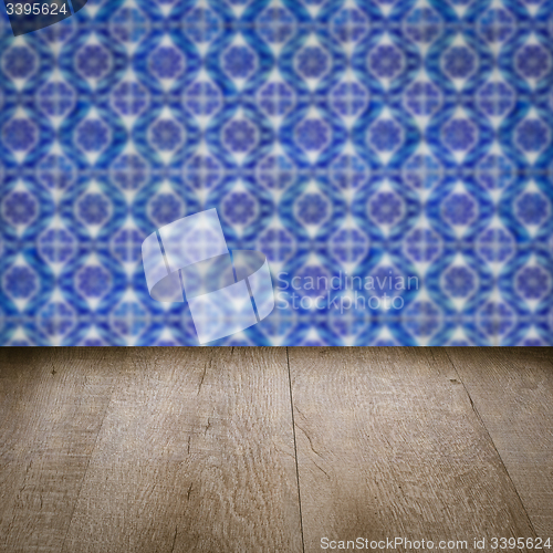 Image of Wood table top and blur vintage ceramic tile pattern wall