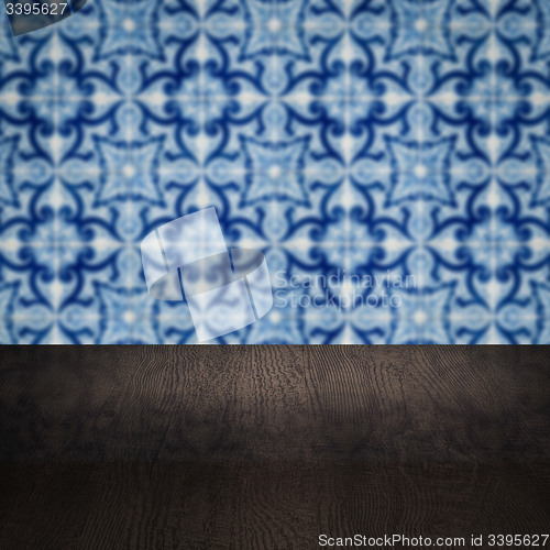 Image of Wood table top and blur vintage ceramic tile pattern wall