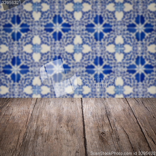 Image of Wood table top and blur vintage ceramic tile pattern wall