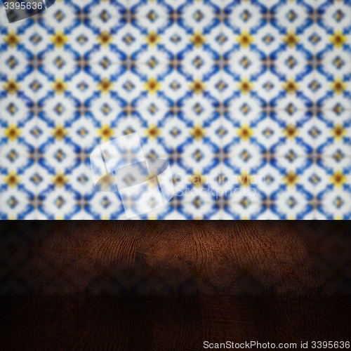 Image of Wood table top and blur vintage ceramic tile pattern wall