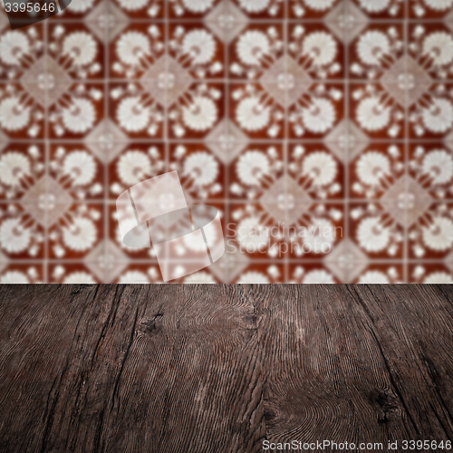 Image of Wood table top and blur vintage ceramic tile pattern wall