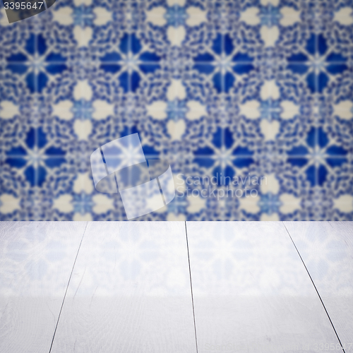 Image of Wood table top and blur vintage ceramic tile pattern wall