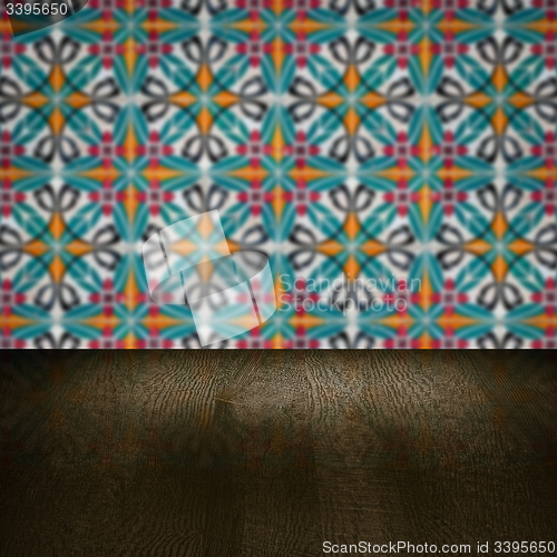 Image of Wood table top and blur vintage ceramic tile pattern wall