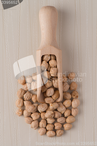 Image of Wooden scoop with chickpeas