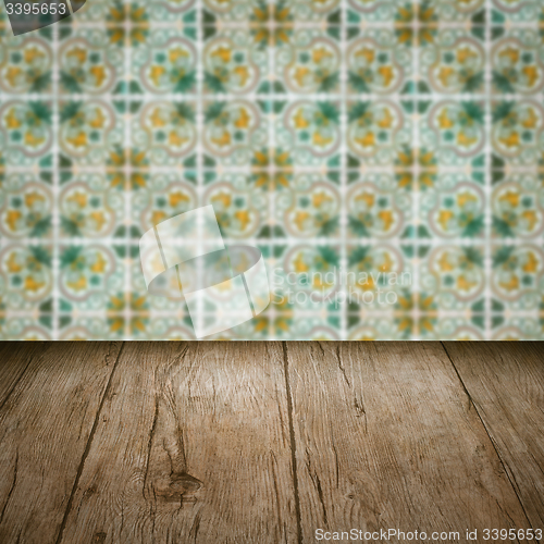 Image of Wood table top and blur vintage ceramic tile pattern wall