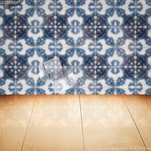 Image of Wood table top and blur vintage ceramic tile pattern wall