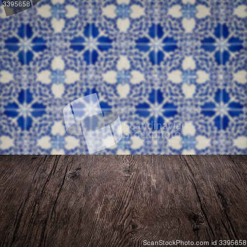 Image of Wood table top and blur vintage ceramic tile pattern wall