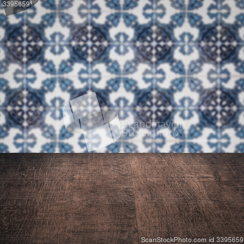Image of Wood table top and blur vintage ceramic tile pattern wall