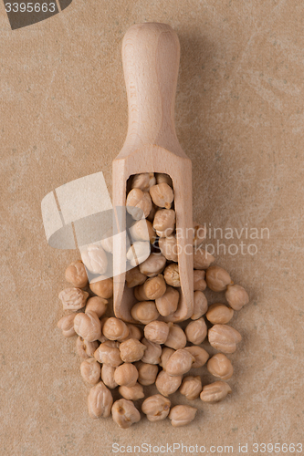 Image of Wooden scoop with chickpeas