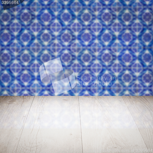 Image of Wood table top and blur vintage ceramic tile pattern wall