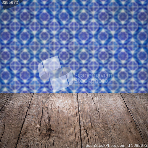 Image of Wood table top and blur vintage ceramic tile pattern wall