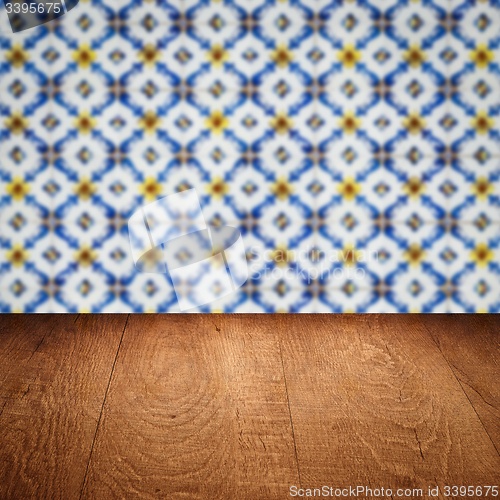 Image of Wood table top and blur vintage ceramic tile pattern wall