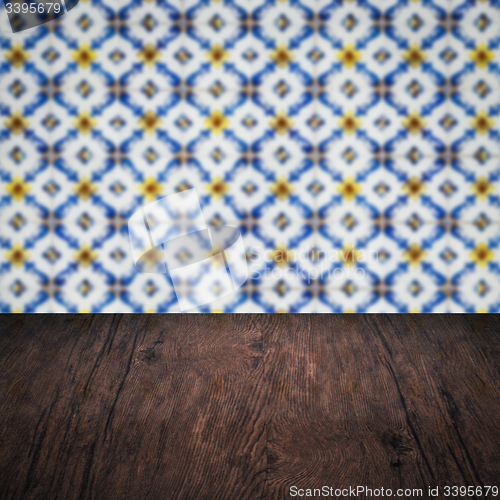 Image of Wood table top and blur vintage ceramic tile pattern wall