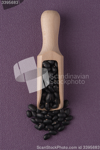 Image of Wooden scoop with black beans