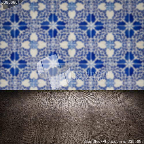 Image of Wood table top and blur vintage ceramic tile pattern wall