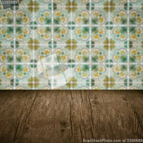 Image of Wood table top and blur vintage ceramic tile pattern wall