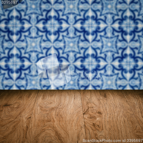 Image of Wood table top and blur vintage ceramic tile pattern wall