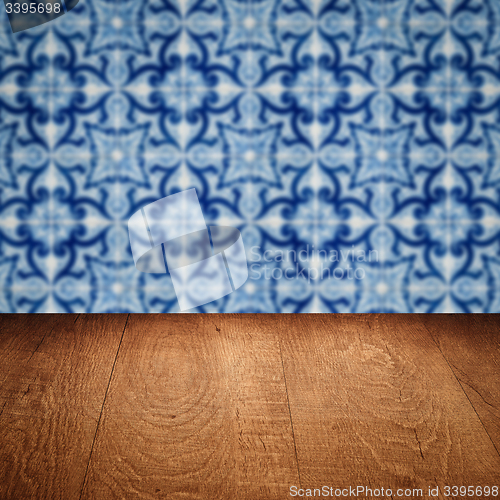 Image of Wood table top and blur vintage ceramic tile pattern wall