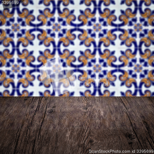 Image of Wood table top and blur vintage ceramic tile pattern wall