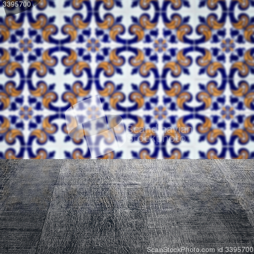 Image of Wood table top and blur vintage ceramic tile pattern wall