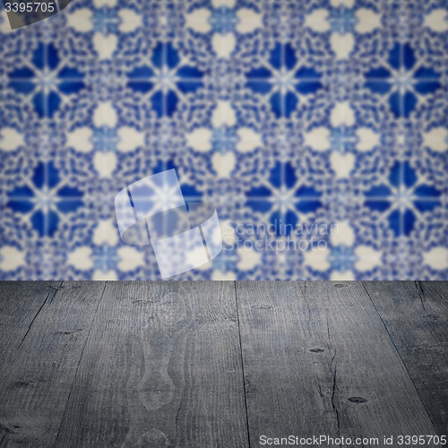 Image of Wood table top and blur vintage ceramic tile pattern wall