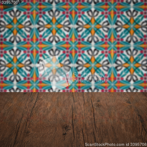 Image of Wood table top and blur vintage ceramic tile pattern wall