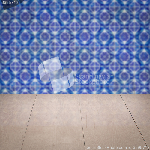 Image of Wood table top and blur vintage ceramic tile pattern wall