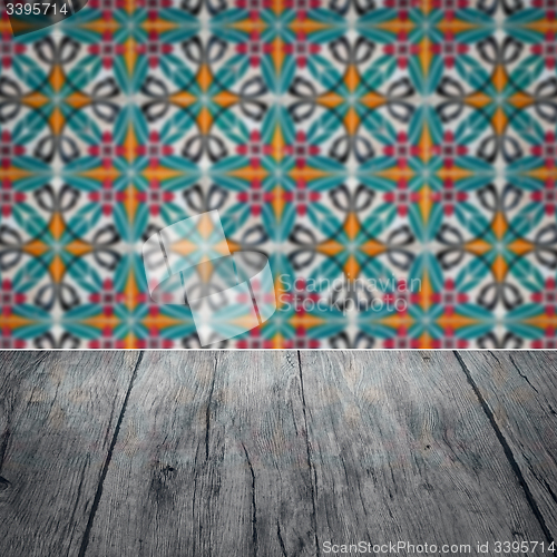 Image of Wood table top and blur vintage ceramic tile pattern wall