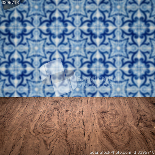 Image of Wood table top and blur vintage ceramic tile pattern wall