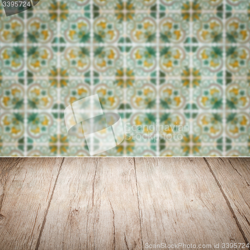 Image of Wood table top and blur vintage ceramic tile pattern wall
