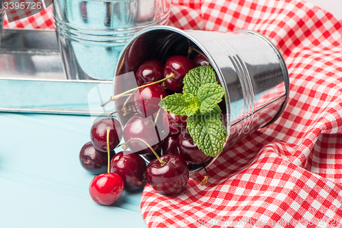Image of Cherries in blue wooden table