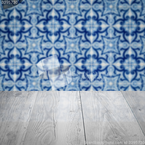 Image of Wood table top and blur vintage ceramic tile pattern wall