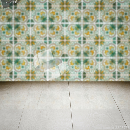 Image of Wood table top and blur vintage ceramic tile pattern wall