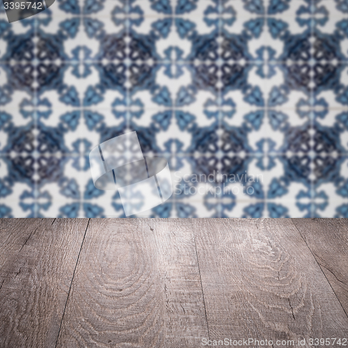 Image of Wood table top and blur vintage ceramic tile pattern wall