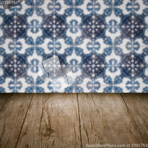 Image of Wood table top and blur vintage ceramic tile pattern wall