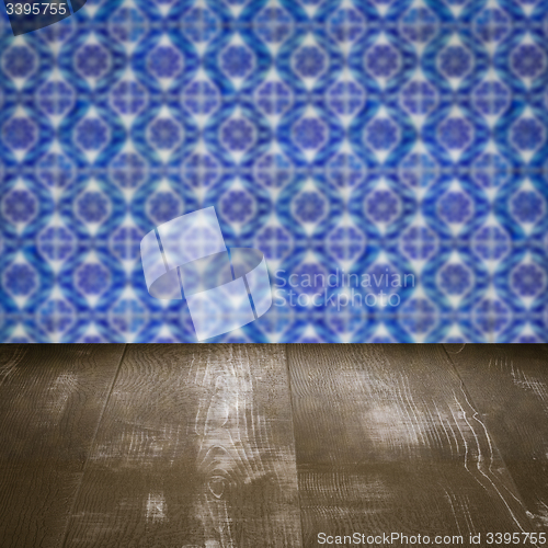 Image of Wood table top and blur vintage ceramic tile pattern wall