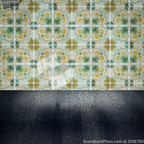Image of Wood table top and blur vintage ceramic tile pattern wall