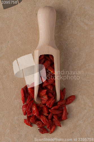 Image of Wooden scoop with dry red goji berries