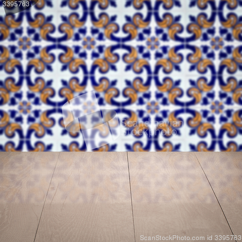 Image of Wood table top and blur vintage ceramic tile pattern wall