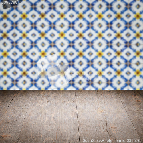 Image of Wood table top and blur vintage ceramic tile pattern wall