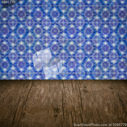 Image of Wood table top and blur vintage ceramic tile pattern wall