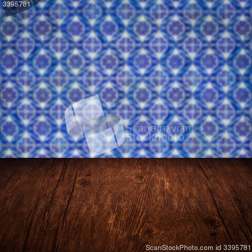 Image of Wood table top and blur vintage ceramic tile pattern wall