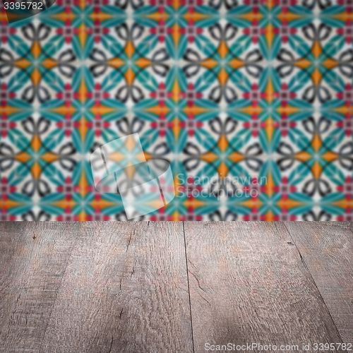 Image of Wood table top and blur vintage ceramic tile pattern wall