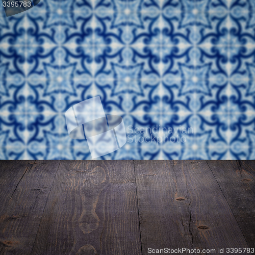 Image of Wood table top and blur vintage ceramic tile pattern wall