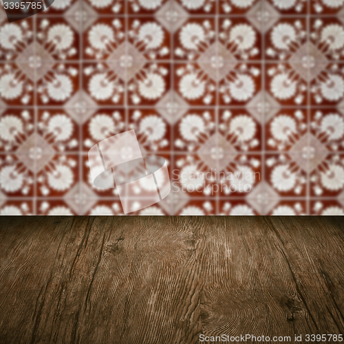 Image of Wood table top and blur vintage ceramic tile pattern wall