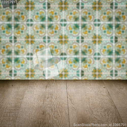 Image of Wood table top and blur vintage ceramic tile pattern wall