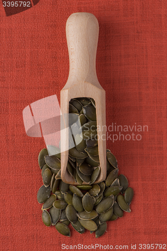 Image of Wooden scoop with pumpkin seeds